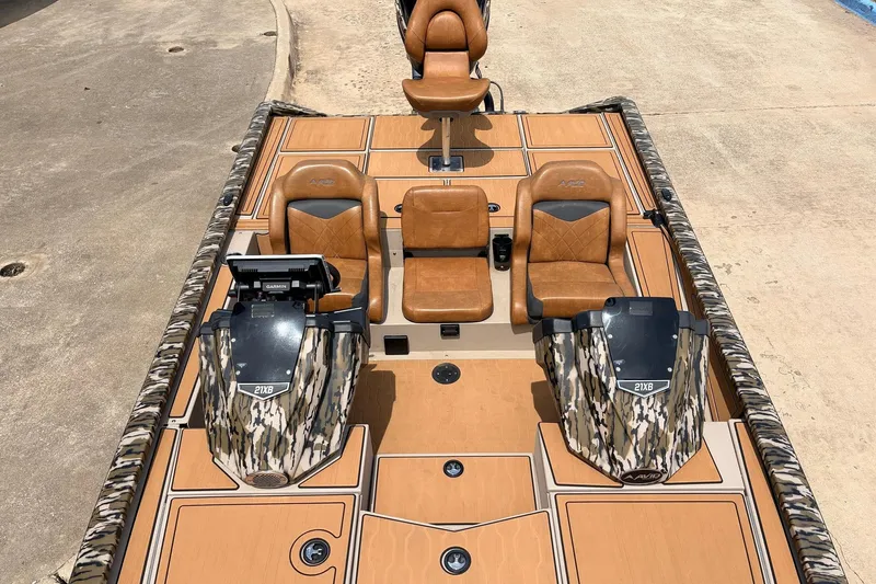 Slide: The Image of 2023 Avid 21 XB Elite boat with camo accents and tan seating. - 28
