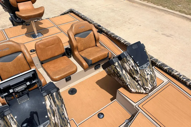 Slide: The Image of 2023 Avid 21 XB Elite boat interior with brown seats and camouflage accents. - 29