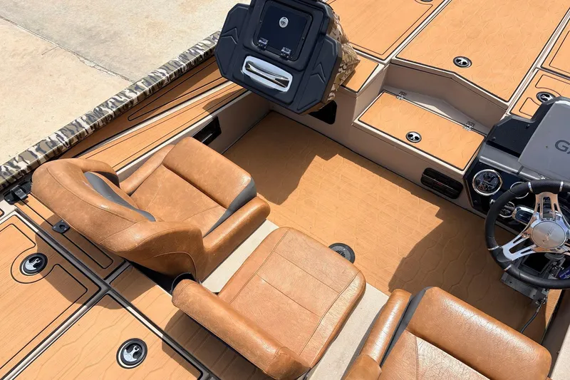 Slide: The Image of 2023 Avid 21 XB Elite boat interior with tan leather seats and modern dashboard. - 32