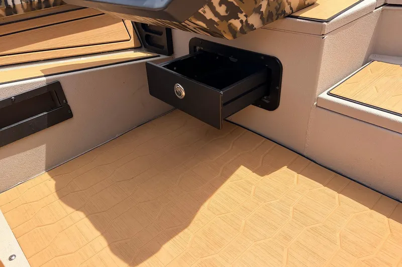 Slide: The Image of 2023 Avid 21 XB Elite boat interior with open storage compartment. - 34