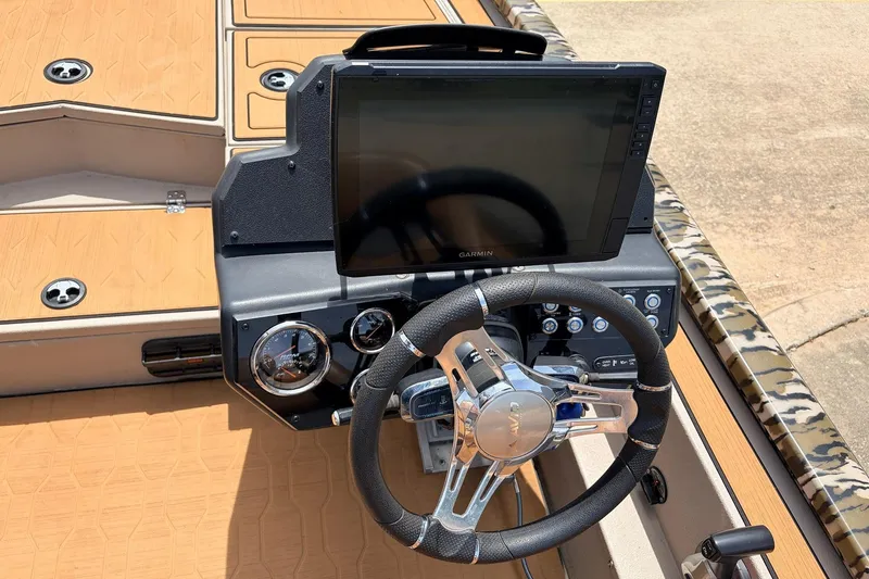 Slide: The Image of 2023 Avid 21 XB Elite boat dashboard with Garmin display and steering wheel. - 36