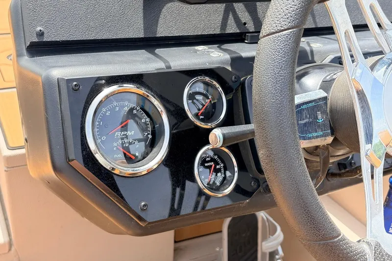 Slide: The Image of Dashboard of 2023 Avid 21 XB Elite boat with gauges and steering wheel. - 37
