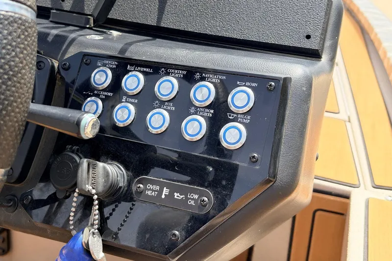 Slide: The Image of Control panel of 2023 Avid 21 XB Elite boat with labeled buttons and switches. - 38