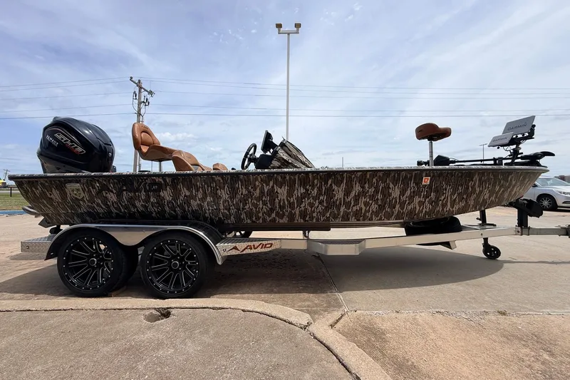 Slide: The Image of 2023 Avid 21 XB Elite boat with camouflage design on a trailer. - 4