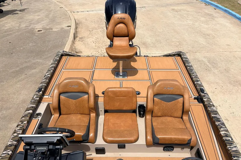 Slide: The Image of 2023 Avid 21 XB Elite boat interior with tan leather seats and Garmin navigation system. - 40