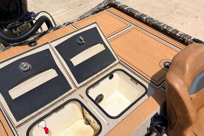 Slide: The Image of 2023 Avid 21 XB Elite boat interior with storage compartments and seating. - 45