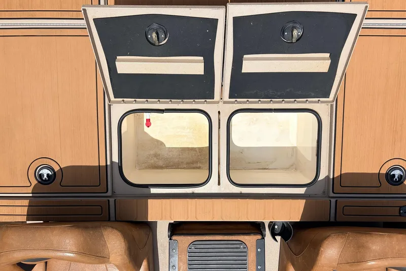 Slide: The Image of 2023 Avid 21 XB Elite boat storage compartments with open lids, showcasing interior space. - 46