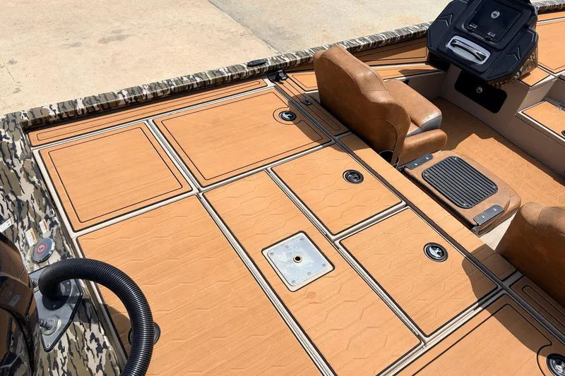 Slide: The Image of 2023 Avid 21 XB Elite boat interior with tan seating and camo accents. - 48