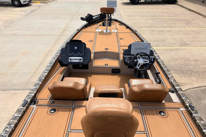 Slide: The Image of 2023 Avid 21 XB Elite boat interior with Garmin navigation system and leather seats. - 8
