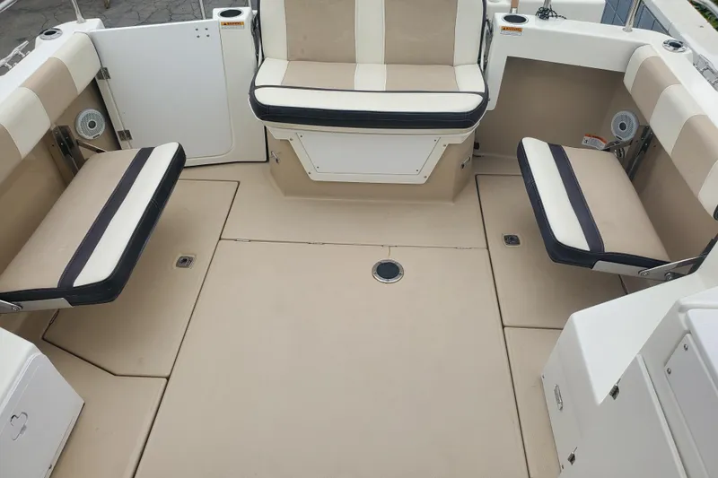 Slide: The Image of 2016 Cutwater 28 boat interior with beige and white seating arrangement. - 10