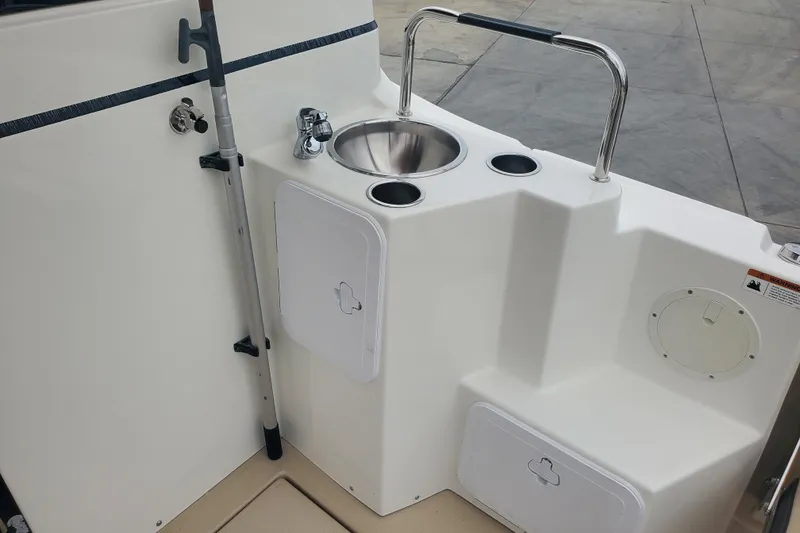 Slide: The Image of 2016 Cutwater 28 boat interior with sink, storage compartments, and rod holder. - 11