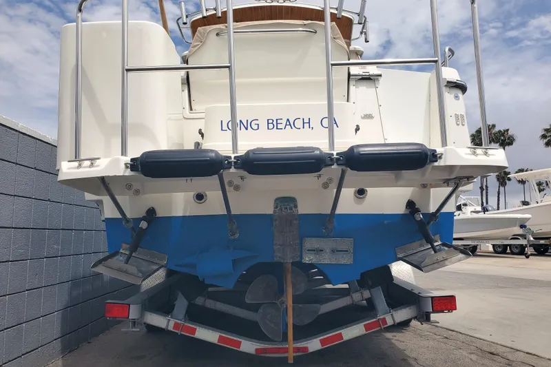 Slide: The Image of 2016 Cutwater 28 boat on trailer, Long Beach, CA, rear view with blue hull. - 16