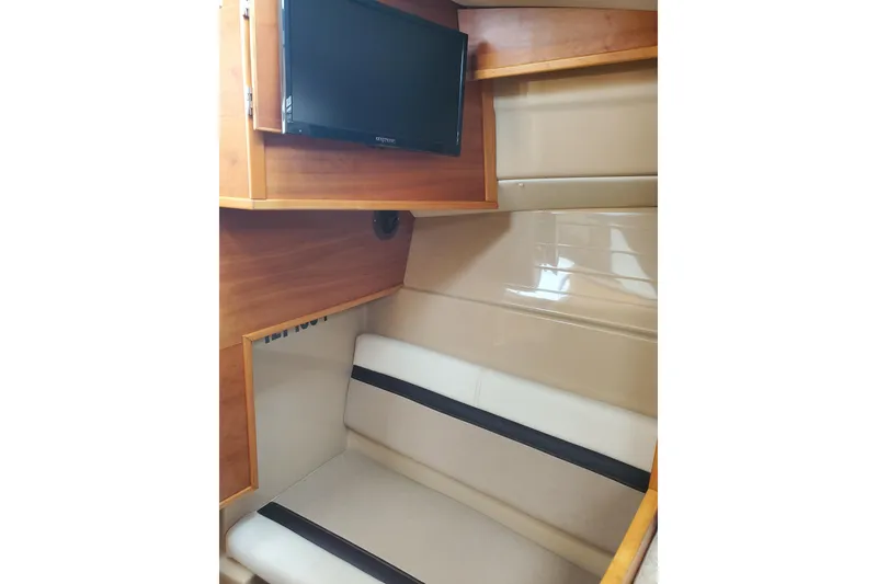 Slide: The Image of Interior of 2016 Cutwater 28 boat with TV and cushioned seating area. - 7