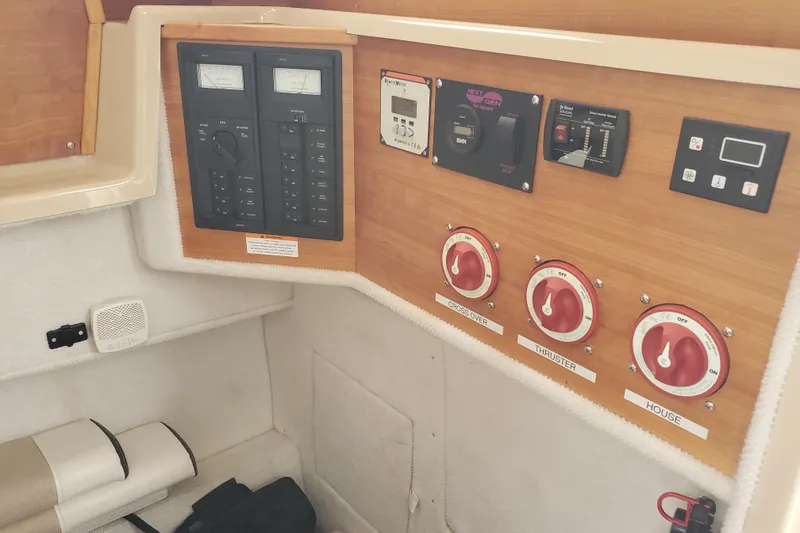 Slide: The Image of Control panel of a 2016 Cutwater 28 boat, featuring switches and gauges. - 9