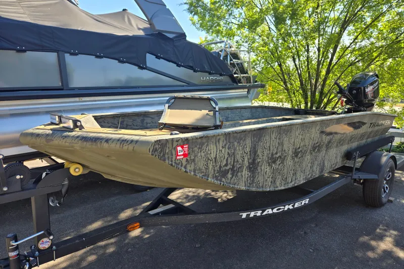 The Image of 2026 Tracker Grizzly 1650 T Prairie Wings Edition boat on trailer, parked outdoors. - 1