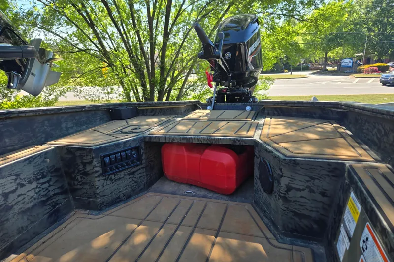 Slide: The Image of 2026 Tracker Grizzly 1650 T Prairie Wings Edition boat interior with motor and storage. - 11