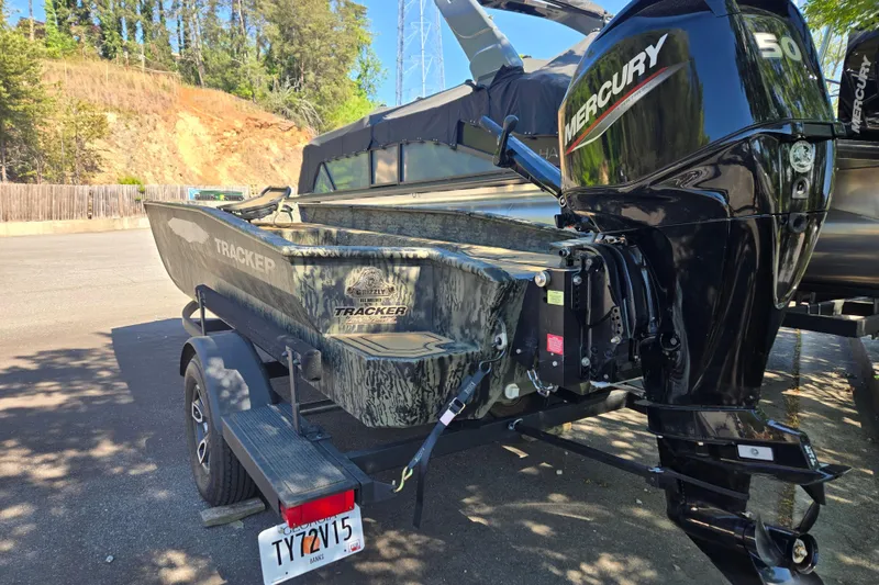 Slide: The Image of 2026 Tracker Grizzly 1650 T Prairie Wings Edition boat with Mercury engine on trailer. - 4