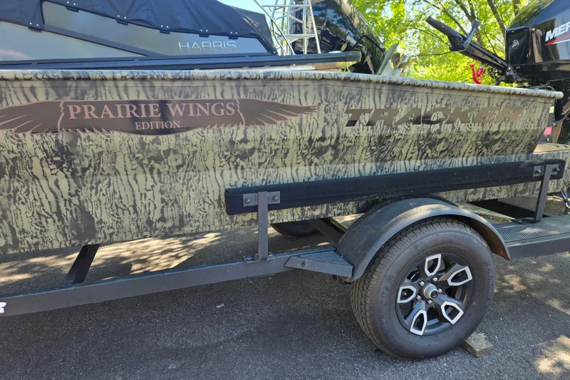 Slide: The Image of 2026 Tracker Grizzly 1650 T Prairie Wings Edition boat on trailer, camo design. - 5