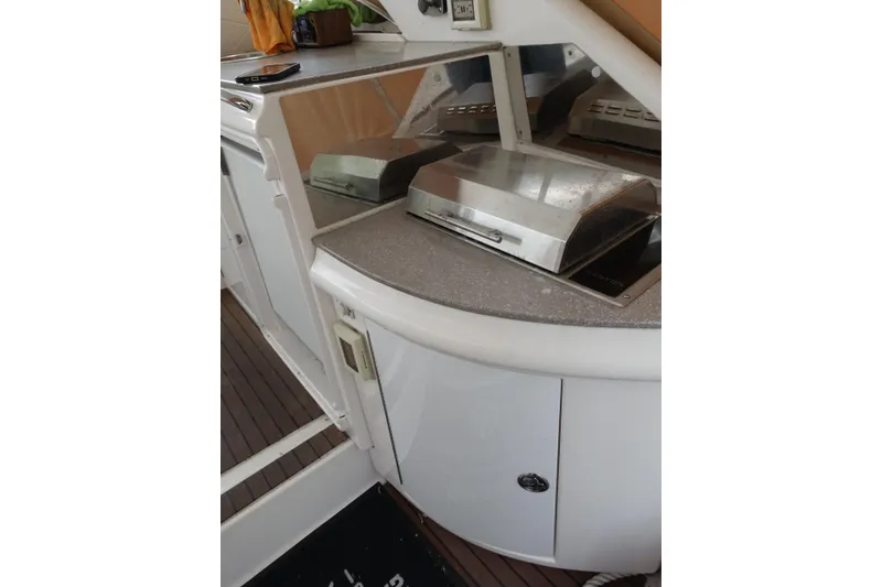 Slide: The Image of 2009 Regal Commodore 4460 yacht interior with built-in grill and countertop. - 10