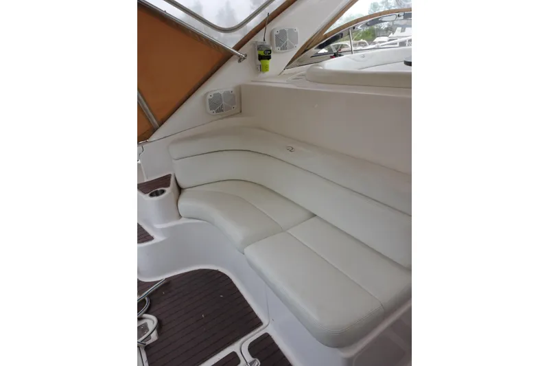 Slide: The Image of 2009 Regal Commodore 4460 boat interior with white leather seating and wood flooring. - 11