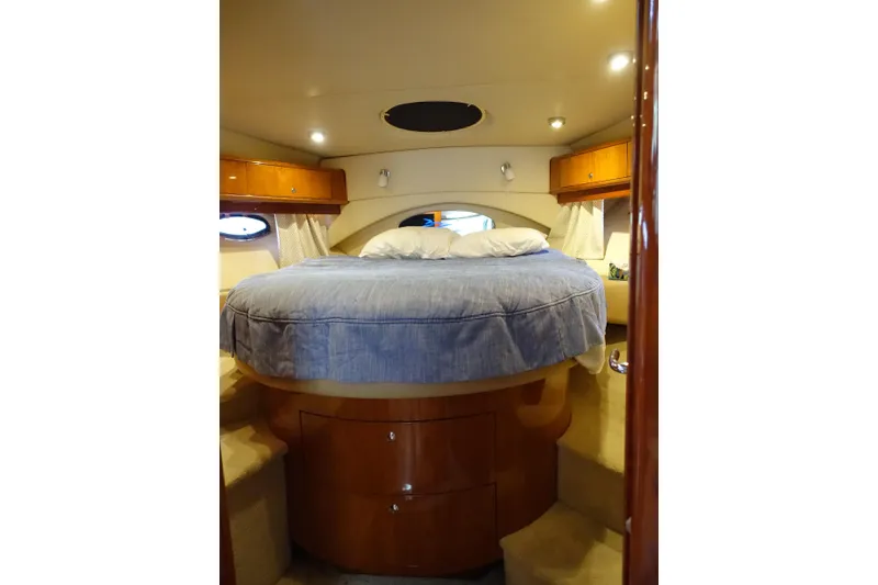 Slide: The Image of Luxurious cabin interior of 2009 Regal Commodore 4460 yacht with cozy bed. - 23