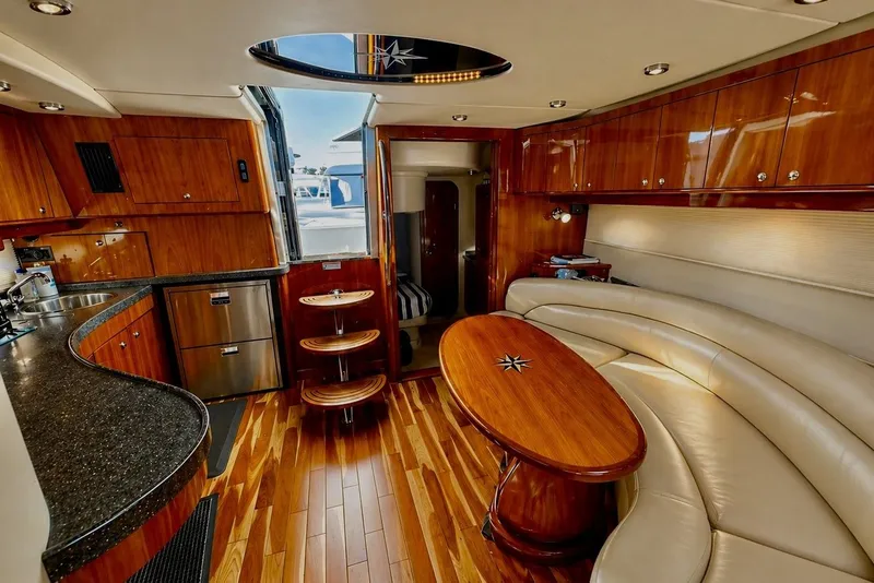 Slide: The Image of Luxurious interior of 2009 Regal Commodore 4460 yacht with wood finishes and leather seating. - 24