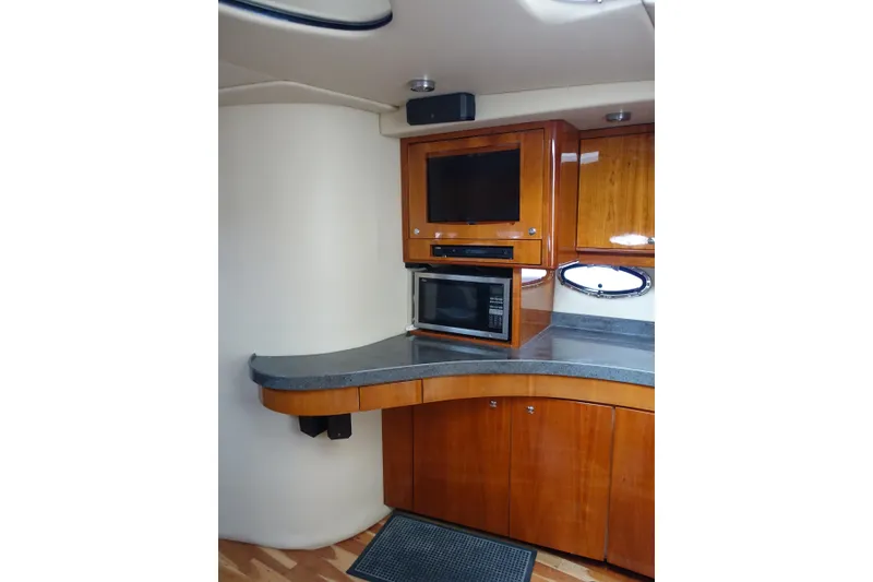 Slide: The Image of Luxurious 2009 Regal Commodore 4460 yacht interior with wooden cabinetry and modern appliances. - 27
