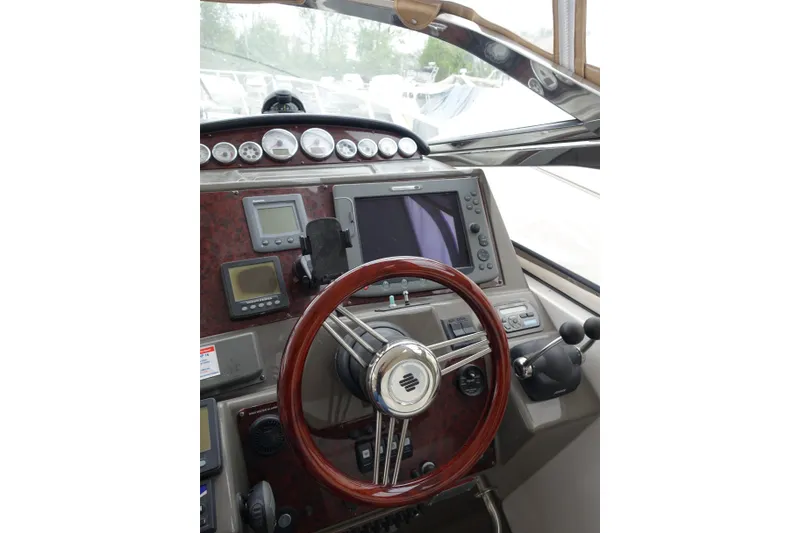 Slide: The Image of Helm of 2009 Regal Commodore 4460 with wooden steering wheel and navigation instruments. - 5