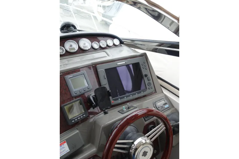 Slide: The Image of Dashboard of 2009 Regal Commodore 4460 boat with navigation instruments and steering wheel. - 6
