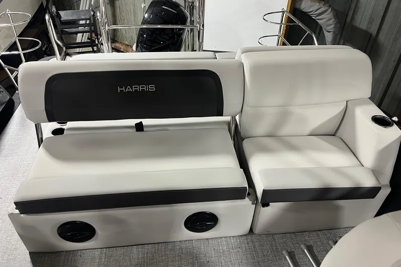 Slide: The Image of 2026 Harris Cruiser 210 SLDH boat seating with white upholstery and integrated cup holders. - 4