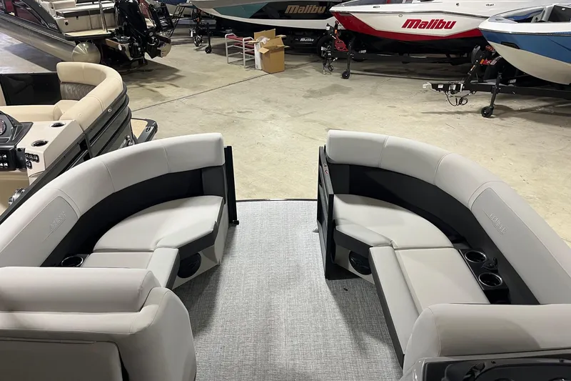 Slide: The Image of 2026 Harris Cruiser 210 SLDH pontoon boat interior with plush seating in showroom. - 5