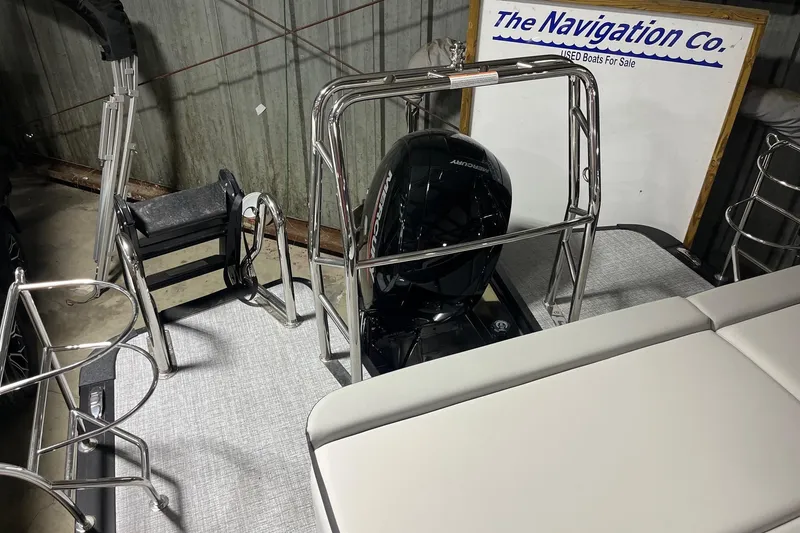Slide: The Image of 2026 Harris Cruiser 210 SLDH boat interior with Mercury engine and seating. - 6