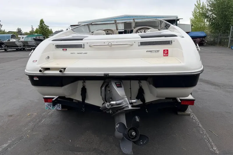 Slide: The Image of 2001 Ebbtide Campione 200 boat rear view in a parking lot. - 2