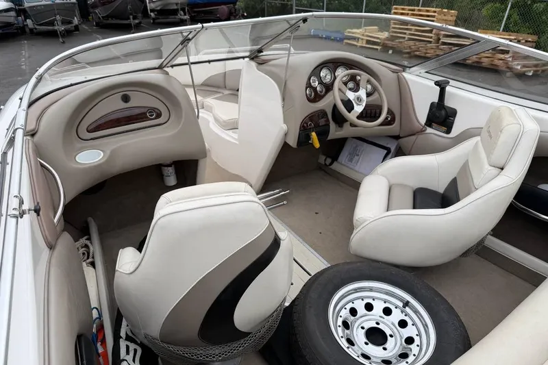Slide: The Image of Interior of a 2001 Ebbtide Campione 200 boat with beige seating and steering wheel. - 3