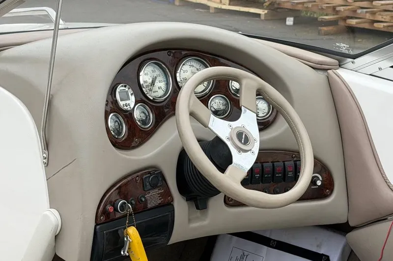Slide: The Image of Dashboard of a 2001 Ebbtide Campione 200 boat with gauges and steering wheel. - 8
