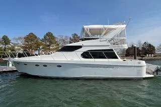 The Image of 2006 Ocean Alexander 48 Sedan yacht docked on calm water. - 0