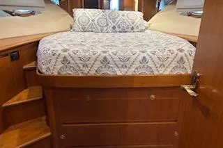 Slide: The Image of Interior cabin of 2006 Ocean Alexander 48 Sedan with bed and wooden storage. - 19