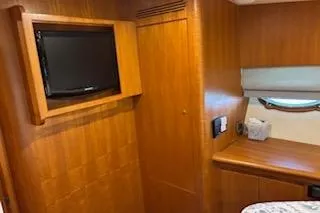 Slide: The Image of 2006 Ocean Alexander 48 Sedan interior with wood paneling and mounted TV. - 20