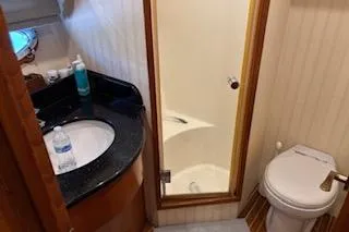 Slide: The Image of Bathroom interior of 2006 Ocean Alexander 48 Sedan yacht, featuring sink and toilet. - 21