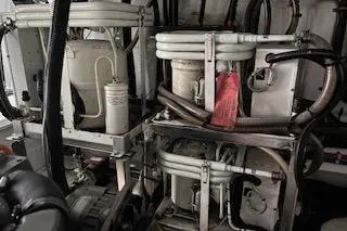 Slide: The Image of Engine room of a 2006 Ocean Alexander 48 Sedan yacht, showcasing mechanical components. - 26
