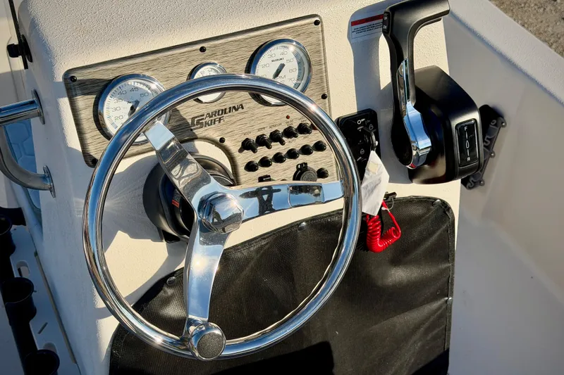 Slide: The Image of Steering console of 2026 Carolina Skiff E16 JVX CC boat with gauges and controls. - 10