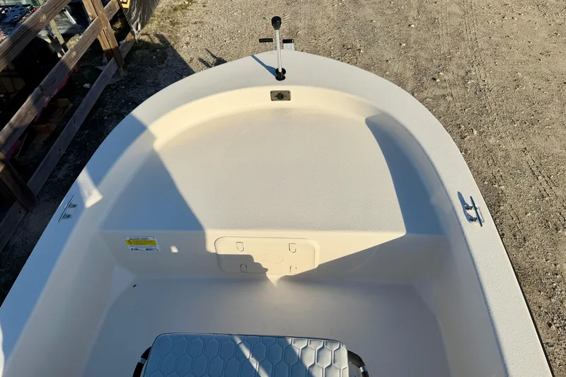 Slide: The Image of 2026 Carolina Skiff E16 JVX CC boat interior, showing seating and steering area. - 11