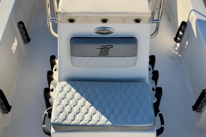 Slide: The Image of 2026 Carolina Skiff E16 JVX CC boat interior with cushioned seating and rod holders. - 12