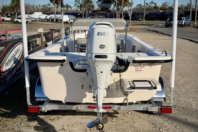 Slide: The Image of 2026 Carolina Skiff E16 JVX CC boat with 60 HP outboard motor, rear view. - 4