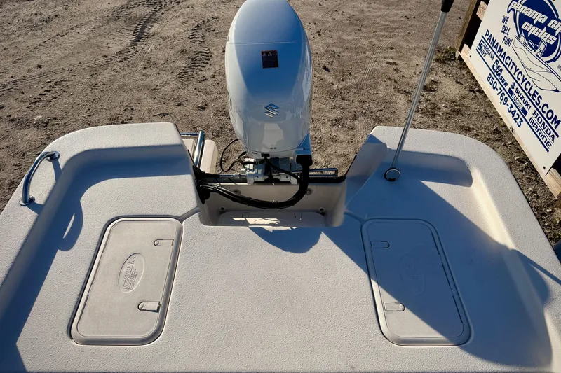 Slide: The Image of 2026 Carolina Skiff E16 JVX CC boat with outboard motor on sandy terrain. - 7