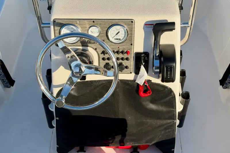 Slide: The Image of 2026 Carolina Skiff E16 JVX CC boat console with steering wheel and controls. - 9