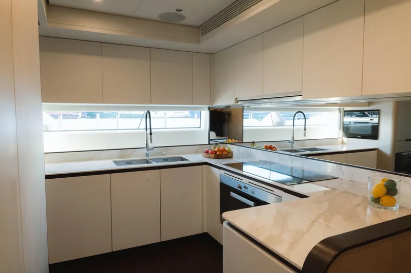 Slide: The Image of Luxurious kitchen interior of 2023 Azimut Grande 32M yacht with modern appliances and sleek design. - 24