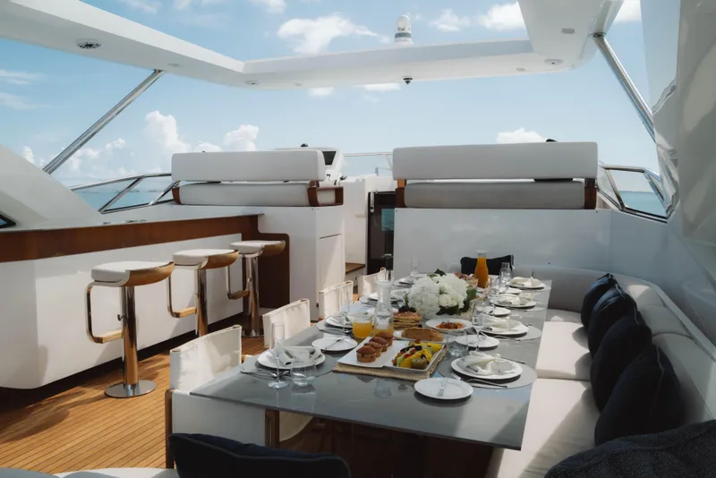 Slide: The Image of Luxurious dining setup on 2023 Azimut Grande 32M yacht, featuring elegant tableware and scenic ocean views. - 6