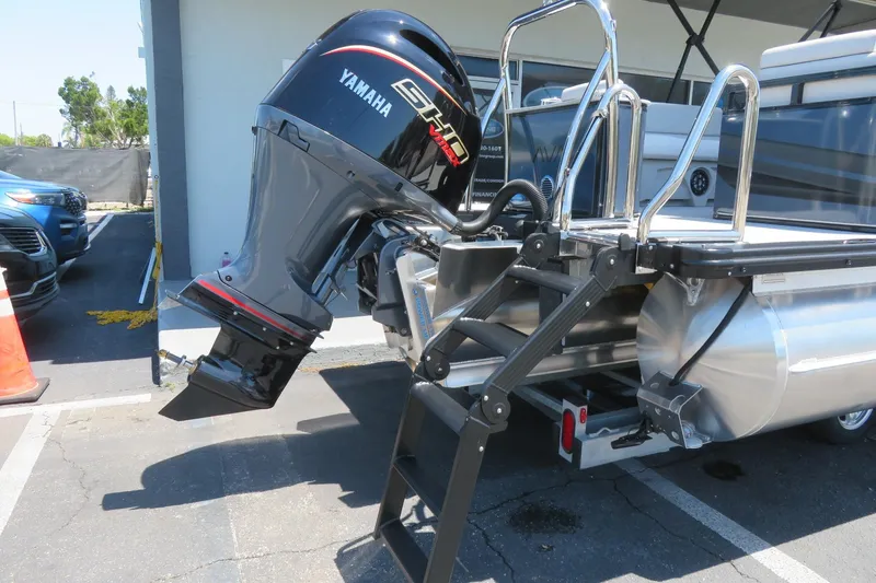 Slide: The Image of 2026 Avalon Venture 85 Quad Lounge with Yamaha motor, rear view showing ladder and engine. - 13