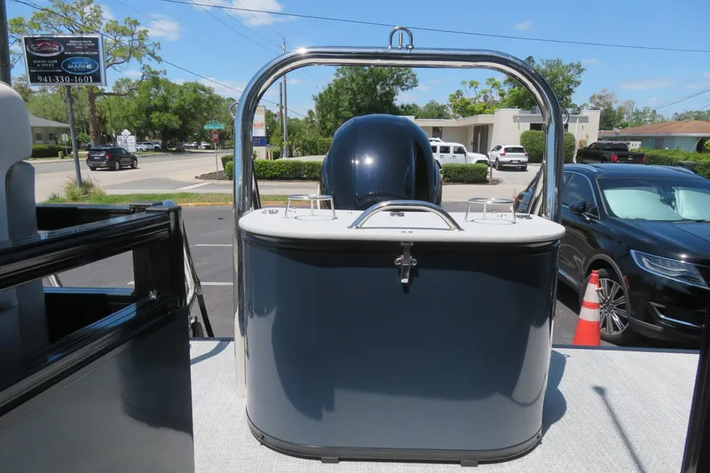 Slide: The Image of 2026 Avalon Venture 85 Quad Lounge boat, rear view, parked outdoors on a sunny day. - 16